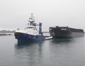 Tug towing barge used to haul steel coils from steel plant to Detroit