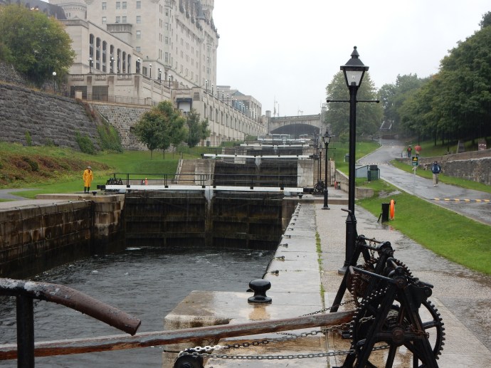 Ottawa locks on Rideau Canal with lock  worker in yellow slicker