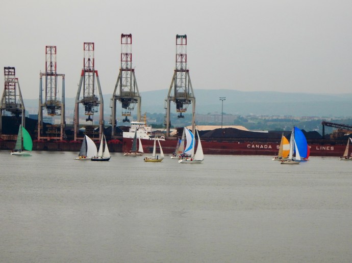 Sailboats along the industrial portion of the river