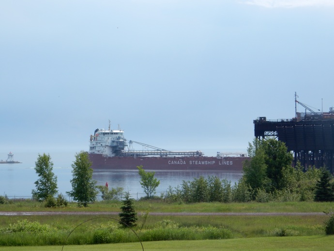 A lakes freighter loaded with taconite pellets heading east