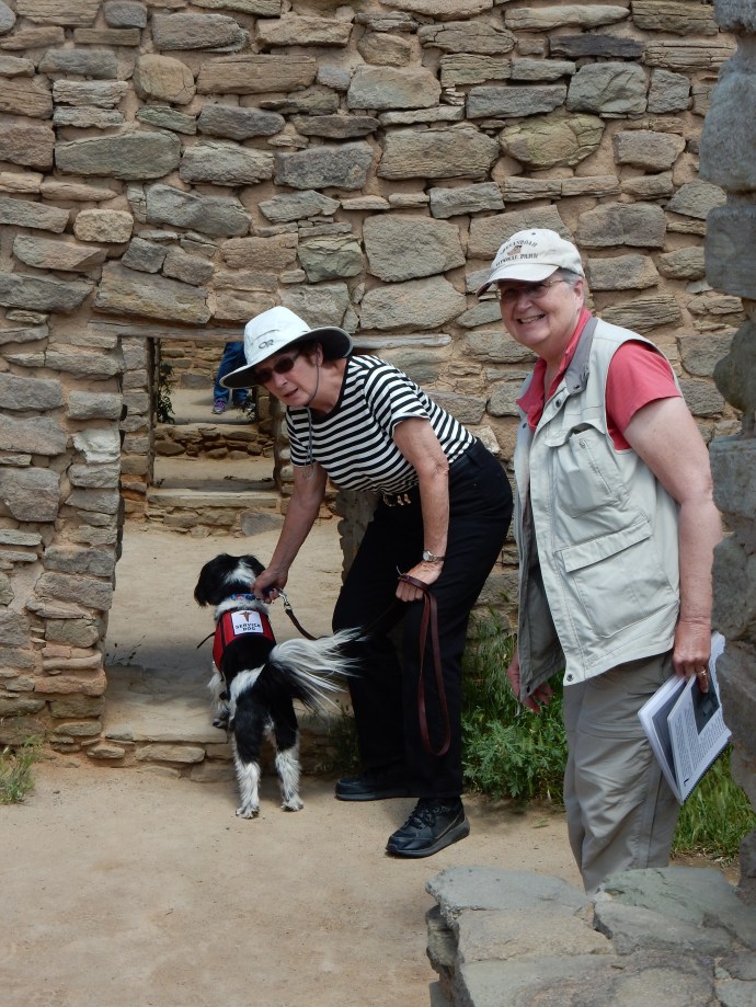 Going through the first of many low doorways at Aztec Ruins