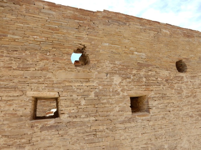 Detail of wall construction with windows and openings where roof beam had been