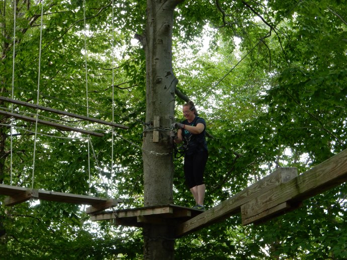 Deb climbing the aerial ropes